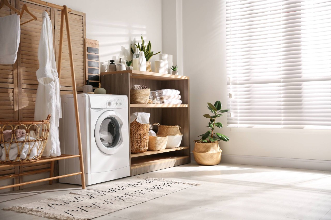 Image of window with metal blinds near a washing machine near Honolulu, HI