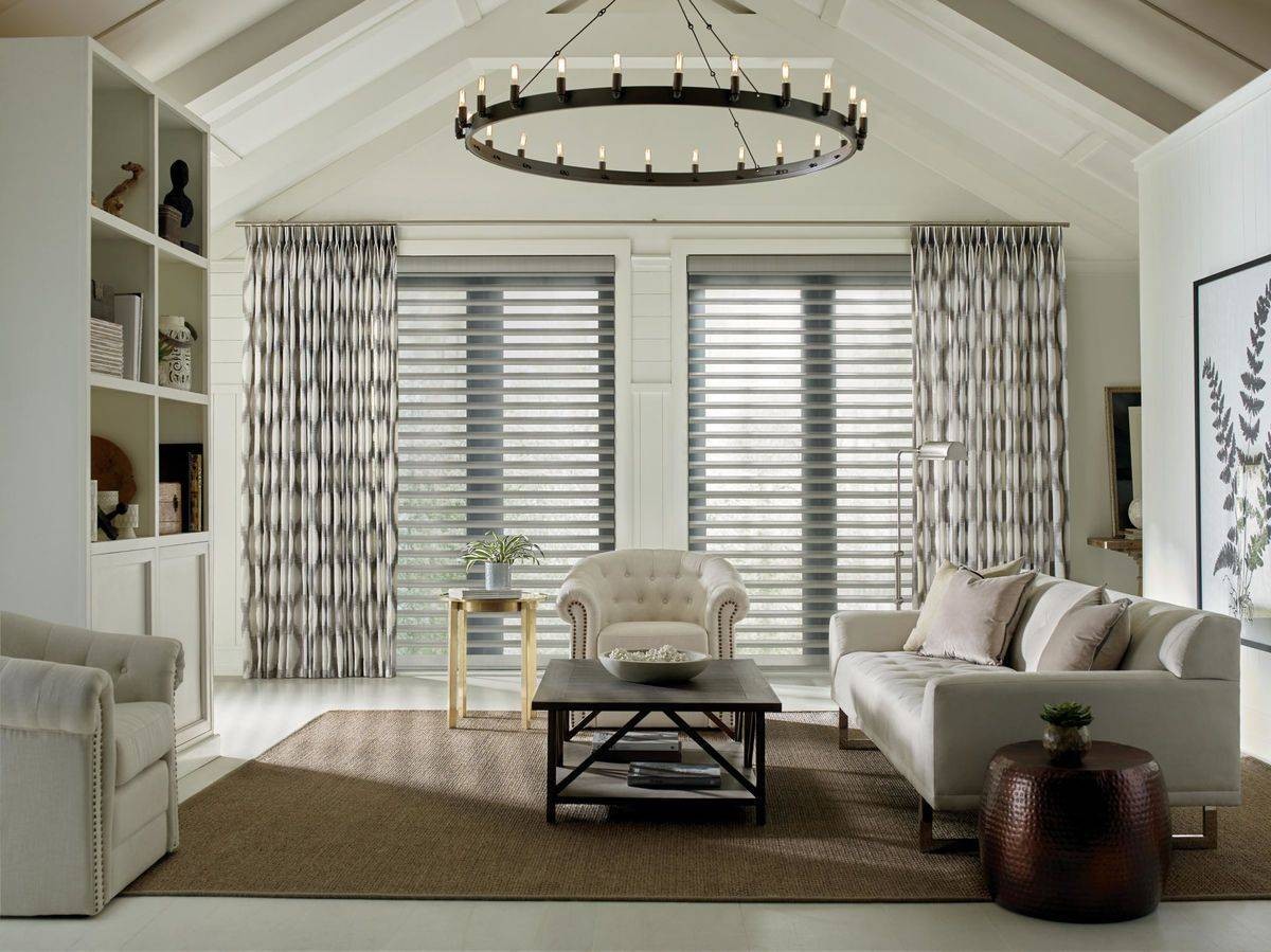 Neutral-colored room with large windows decorated with blinds and drapes near Honolulu, HI