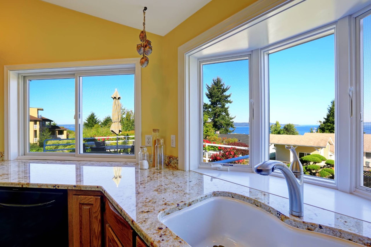 Sunshine yellow kitchen with bay windows over a kitchen sink at Design 5 Ltd. near Honolulu, HI
