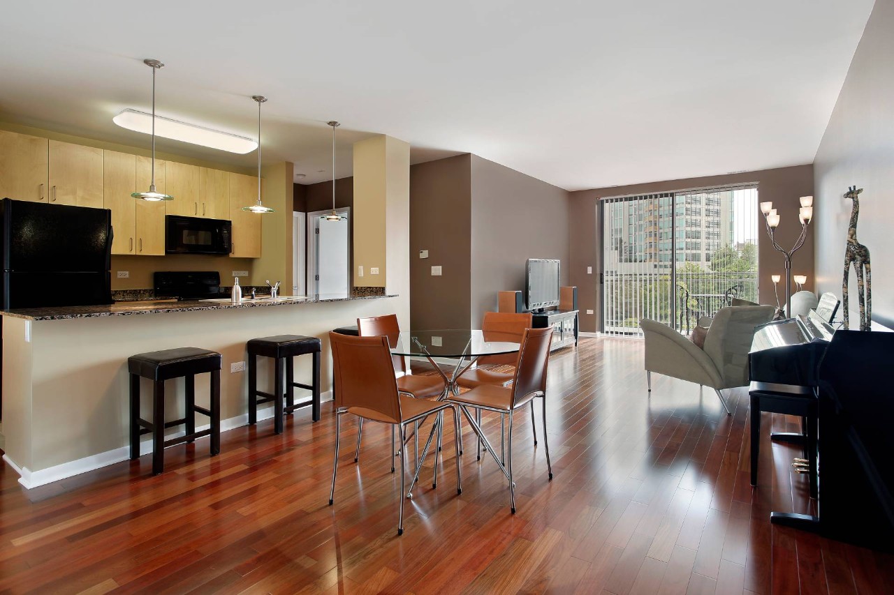 A condo with an open floor plan layout and sliding glass doors with vertical blinds near Honolulu, HI
